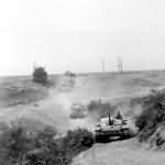 StuG 40 advancing along a dusty road towards the front lines