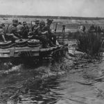Camouflaged German troops atop StuG III Operation Barbarossa