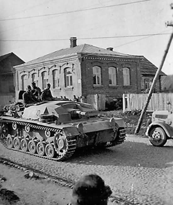 StuG III Ausf B Passing on Street Russia