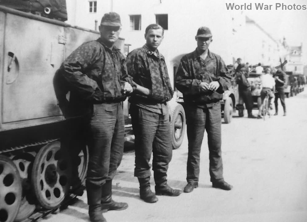Waffen-SS soldiers posing beside a Sd.Kfz 11 | World War Photos