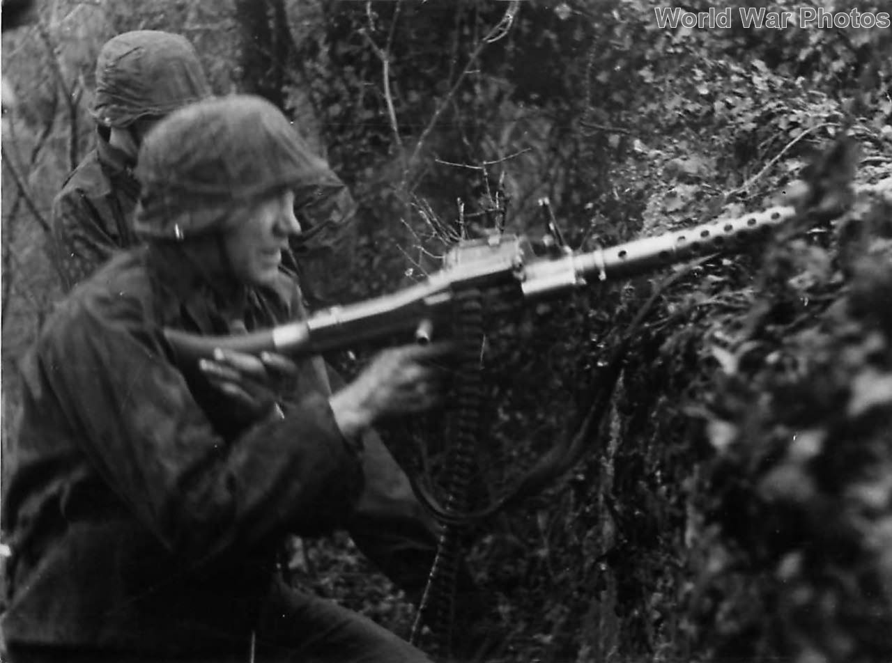 Waffen SS trops with MG 34 attacking village on Eastern Front
