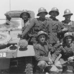 A group of Italian soldiers posing with a Kubelwagen DAK 1941