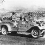 U.S. troops riding in a Volkswagen captured in Sicily