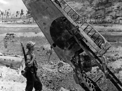 Seabee Inspects Wing of Wrecked A6M Zero at Munda Airport