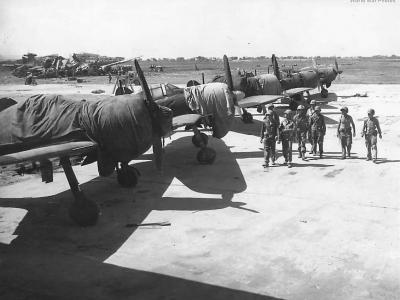 U.S. troops with intact Zeros at Aslito Airfield Saipan