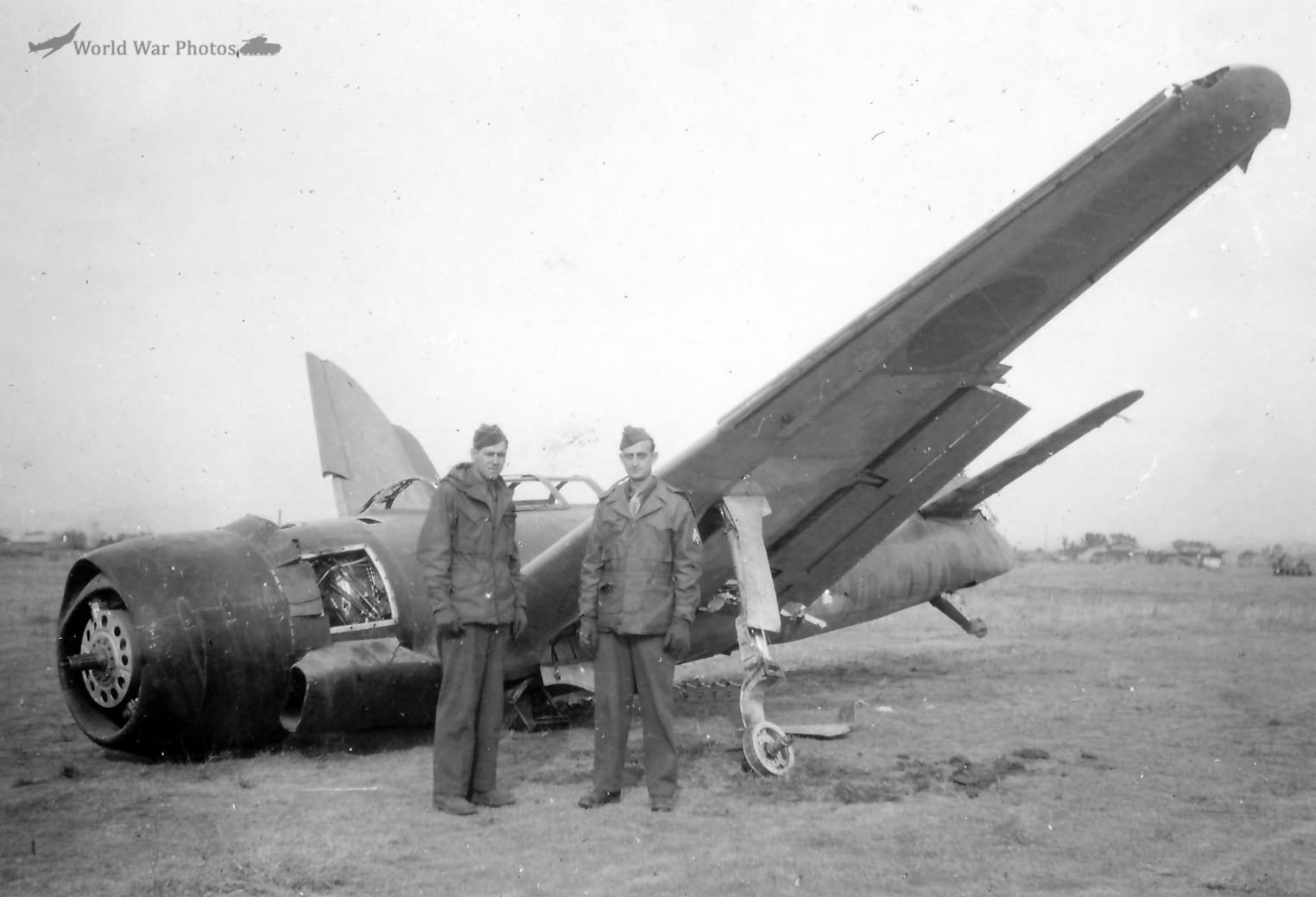 6th Army GIs next to wrecked C6N