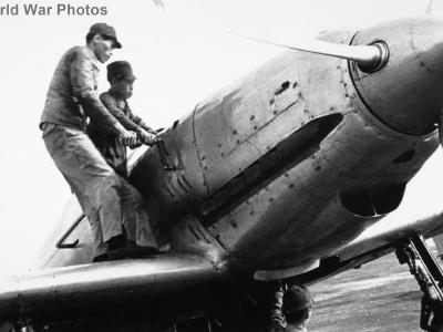 Mechanics using a hand crank to start the engine of Ki-60