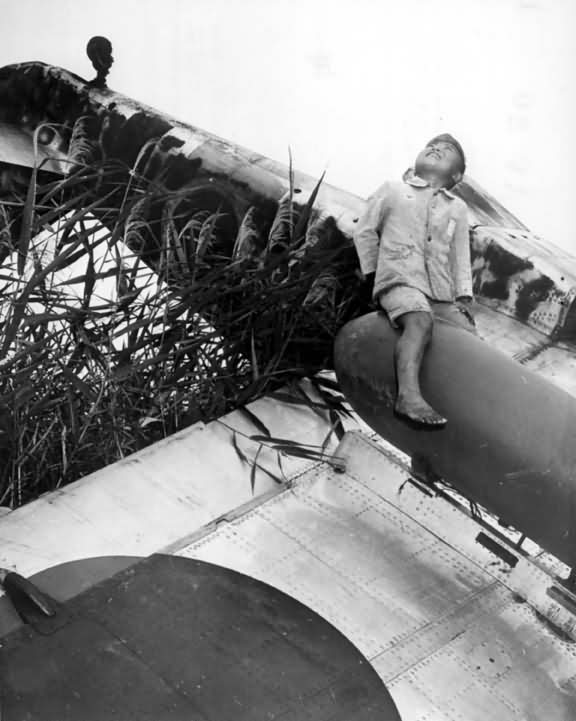 Japanese Boy atop wreck of Kawasaki Ki-61 Hien Tony in Japan 1945