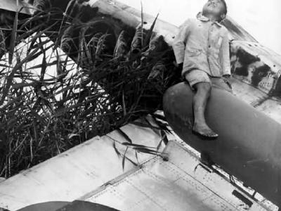 Japanese Boy atop wreck of Kawasaki Ki-61 Hien Tony in Japan 1945