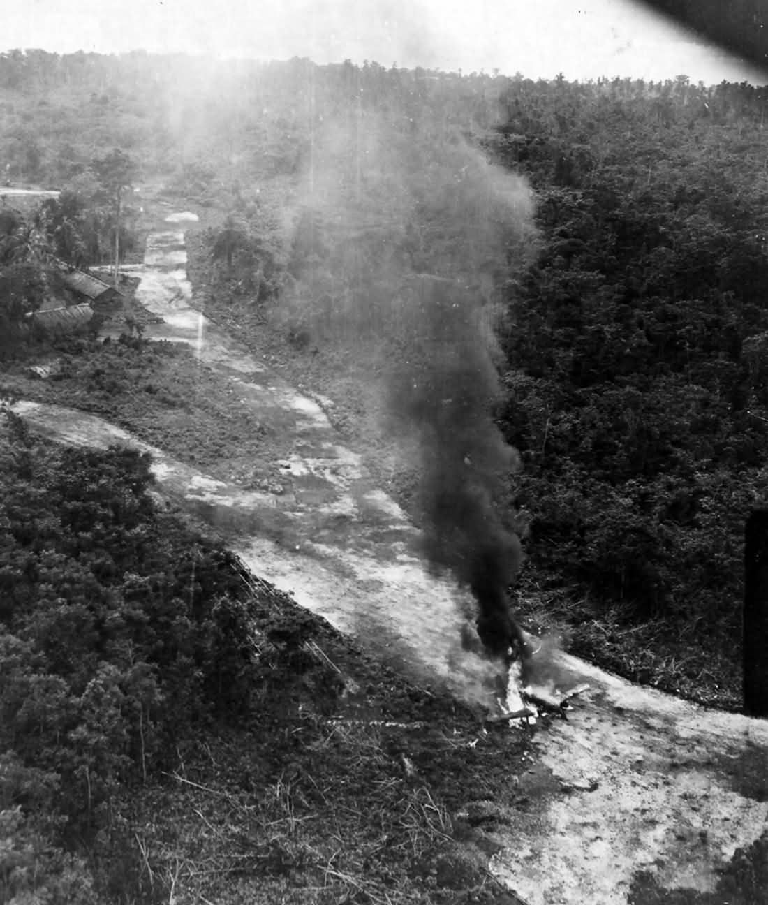 Ki-61 Hien burns at Kamiri Netherlands East Indies after attack of the 3rd Bombardment Group 8th BS 5th Air Force May 21 1944
