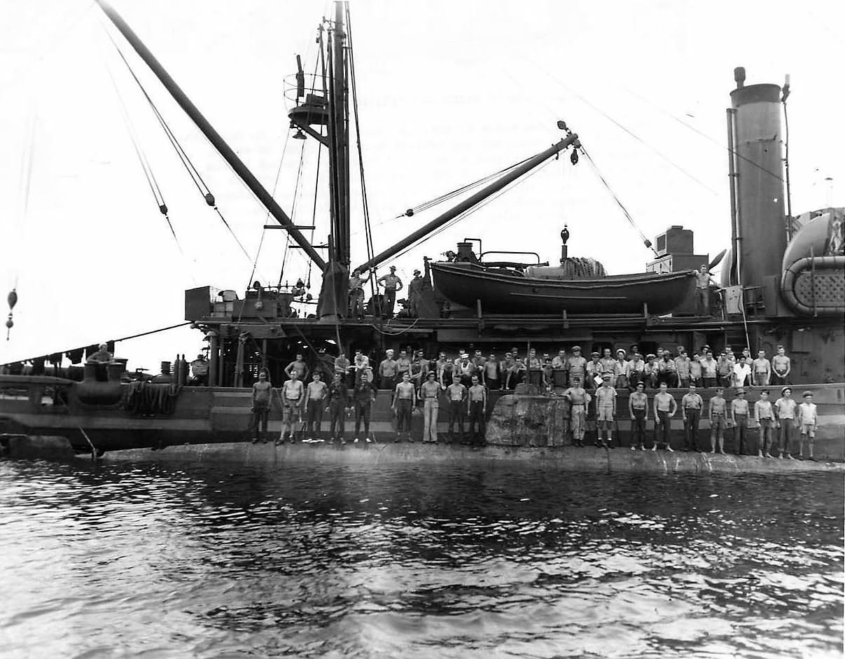 Crew of the submarine rescue vessel USS Ortolan ASR-5 standing on the hull of Japanese midget submarine Ha-8 which they raised just off the coast of Guadalcanal 1943