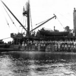 Crew of the submarine rescue vessel USS Ortolan ASR-5 standing on the hull of Japanese midget submarine Ha-8 which they raised just off the coast of Guadalcanal 1943