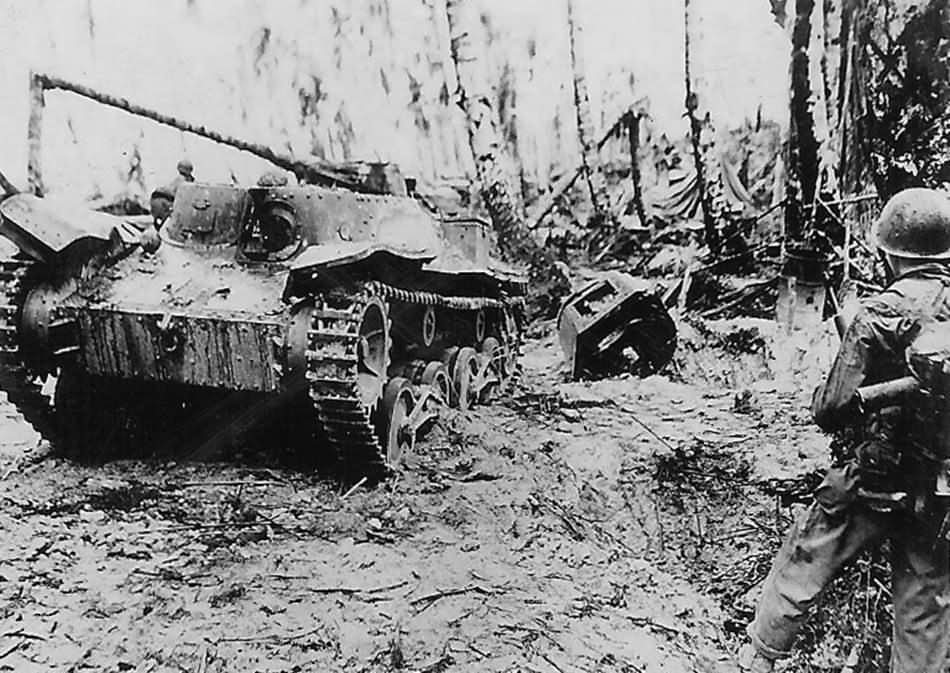 US Troops in jungle with Knocked Out Japanese tank Ha-Go