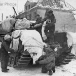 Churchill crew use white bed sheets to help camouflage their tank