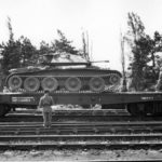 Covenanter loaded onto a flatbed railway car