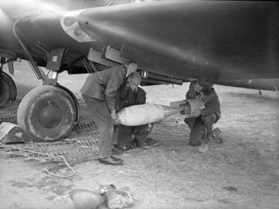 Armourers load a bomb into the Battle of No. 103 Squadron RAF at Betheniville