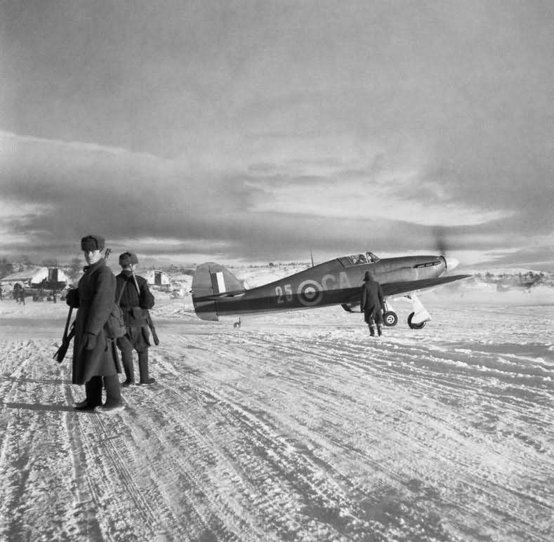 Hurricane Mk IIB Z5253 GA-25 of No 134 Squadron RAF taxies out past Russian sentries at Vaenga