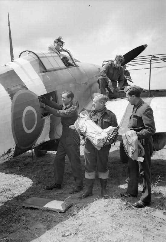 Mail being loaded into a Hurricane Mk IIC of No 1697 Air Despatch Letter Service Flight at B2 Bazenville Normandy 1944