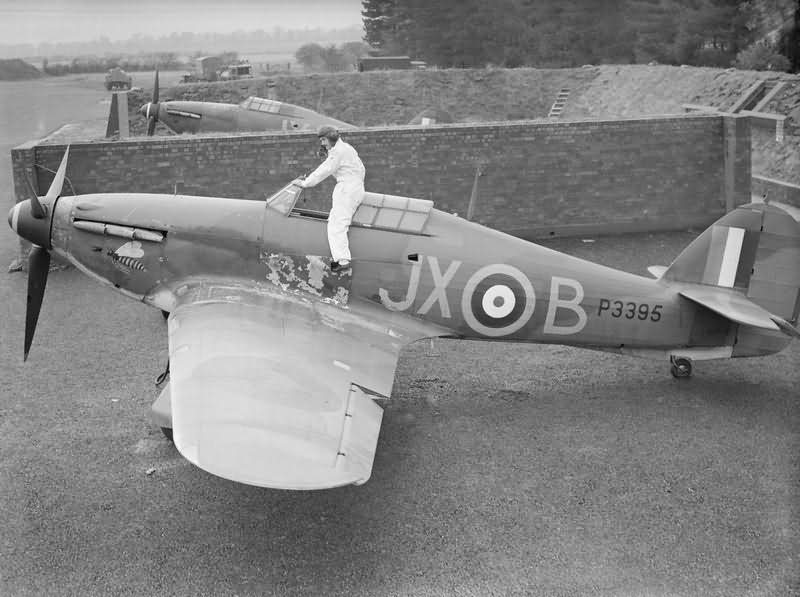PO Clowes of No 1 Squadron RAF climbing into his Hurricane Mk I P3395, code JX-B in a revetment at Wittering