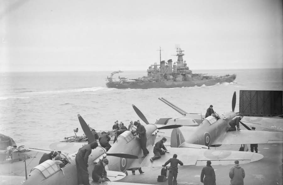 Sea Hurricanes on the flight deck of HMS Victorious with the battleship USS WASHINGTON in the foreground JULY 1942