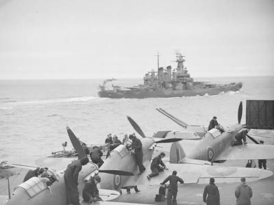 Sea Hurricanes on the flight deck of HMS Victorious with the battleship USS WASHINGTON in the foreground JULY 1942