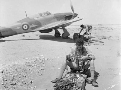 Sgt Dean of No 274 Squadron RAF examines belts of .303 ammunition Sidi Barrani Egypt Hurricane Mk I P2638