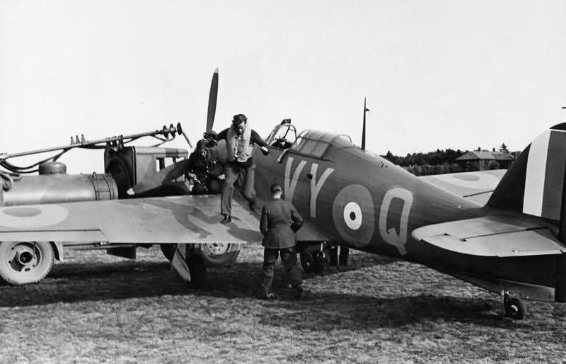 Sqn Ldr Peter Townsend jumps down from Hurricane Mk I P3166 VY-Q No 85 Squadron while being refuelled at Castle Camps July 1940