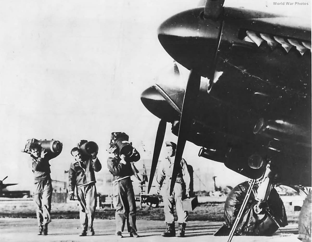Crewmen load aerial cameras on to a Mosquito