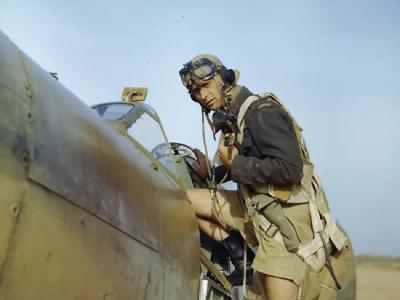 Pilot of No 417 Squadron climbing into the cockpit of his Spitfire at Goubrine