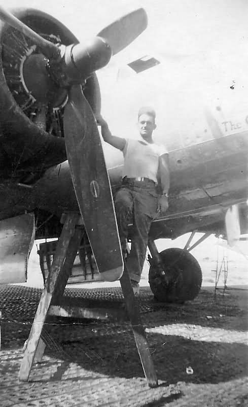 Mechanic servicing engine on B-17 Bomber