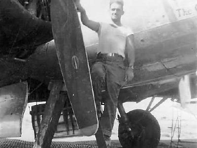 Mechanic servicing engine on B-17 Bomber