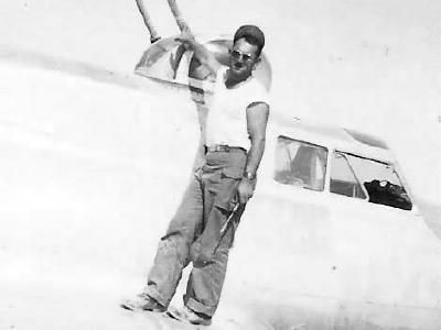 Mechanic servicing top turret on B-17 bomber