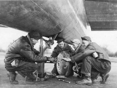 Mechanics changing tail wheel on B-17 Bomber 385th Bomb Group