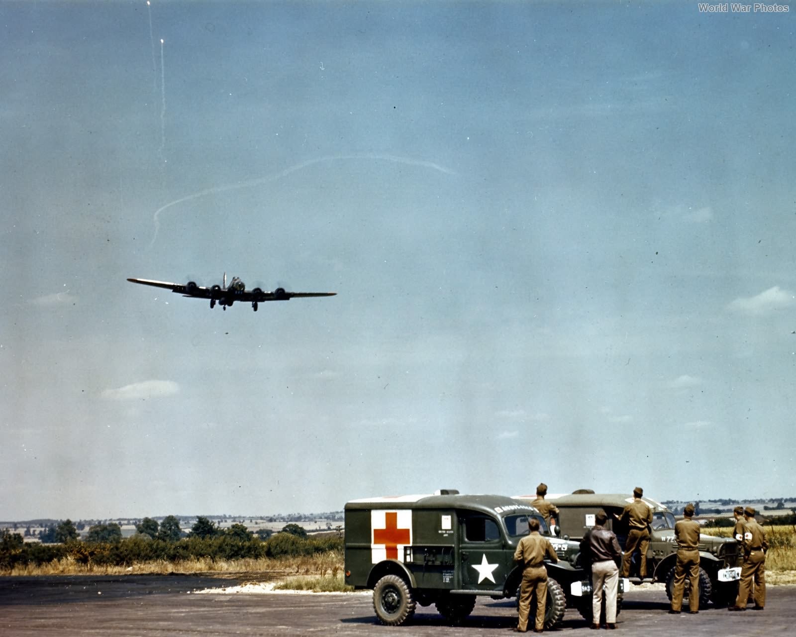 Crippled 8th AF B-17 in pattern over WC-54 Ambulances England 44
