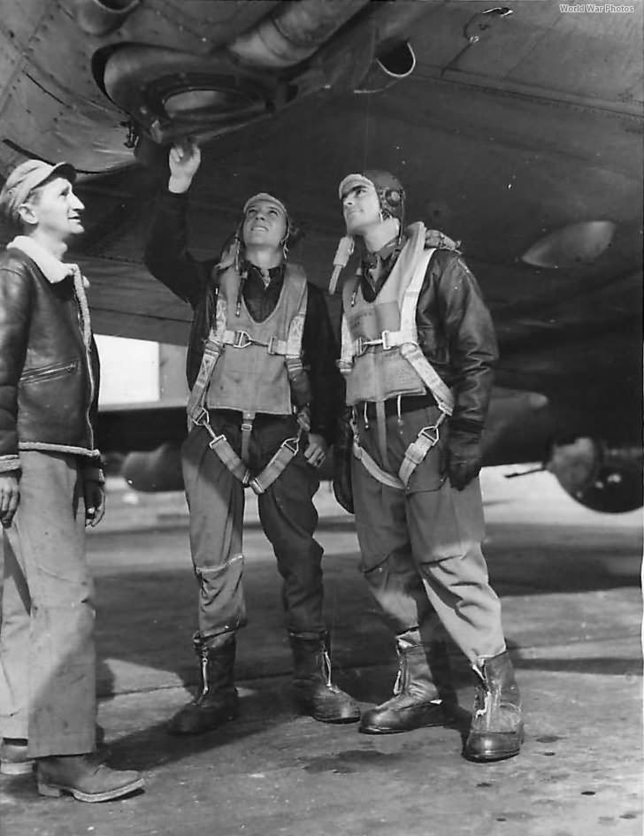 Pilots and Crew Chief check supercharger on B-17