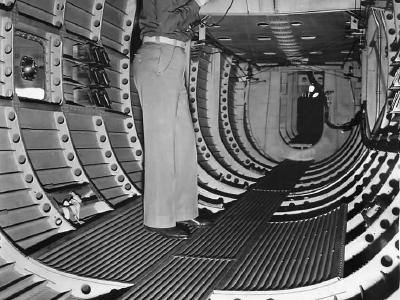 Lieutenant pictured talking on the phone in rear section of the fuselage of a Douglas XB-19