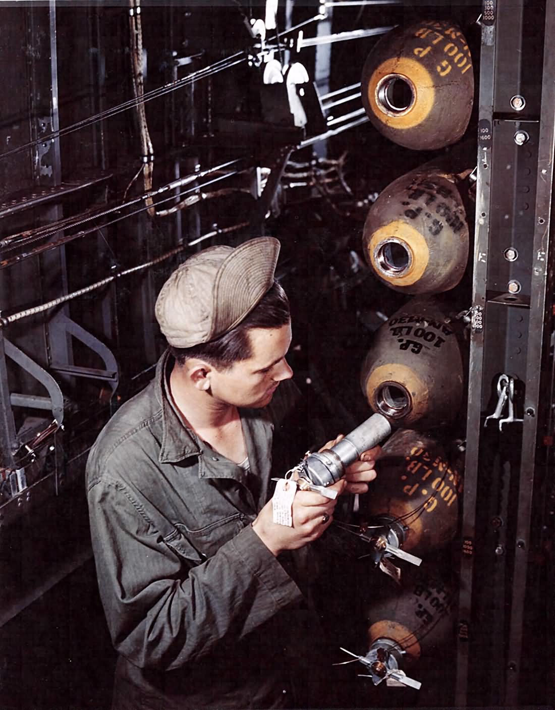 100 lb bombs already in the bomb bay of a Consolidated B-24 England