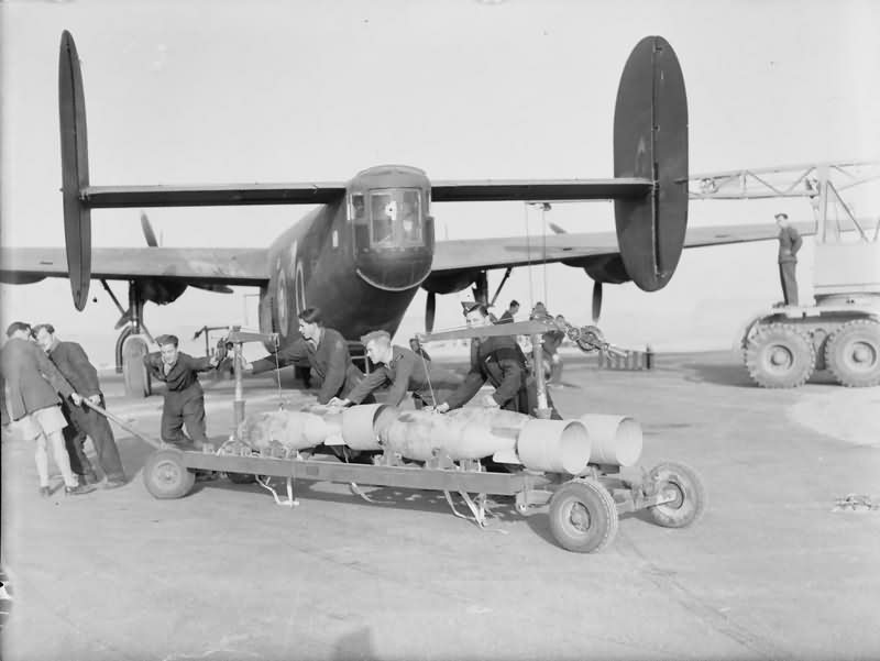Armourers hauling a trolley of 500 lb bombs