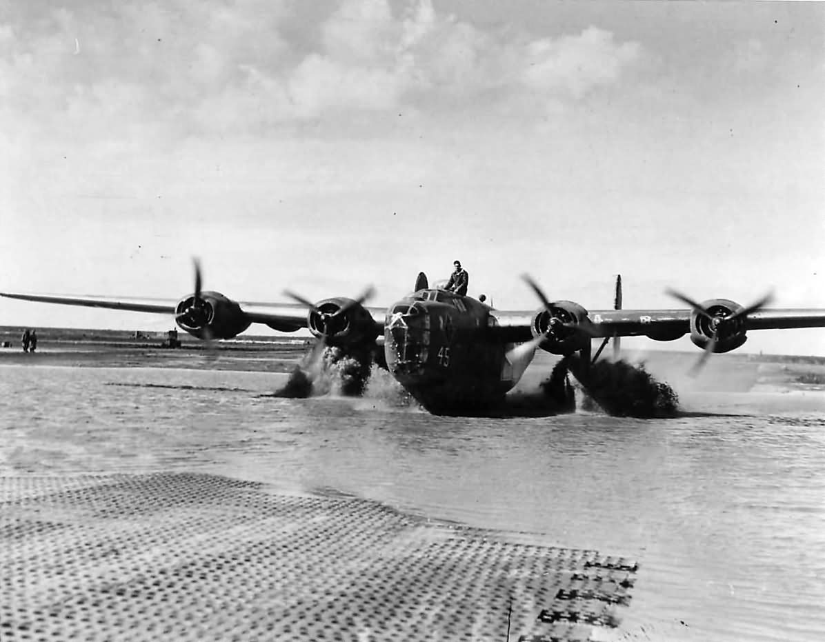 B-24D Liberator taxis across a flooded San Pancrazio airfield