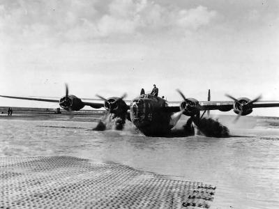 B-24D Liberator taxis across a flooded San Pancrazio airfield