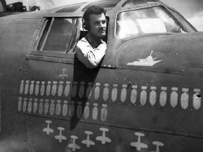Col. Bullis of Jolly Rogers 90th BG by Scoreboard on B-24 1944