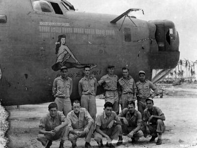 Lt. Woodard and crew of the 394th Bomb Squadron 5th Bomb Group pose beside the B-24 „Bombs To Nip On!”