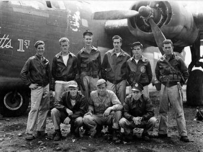 Crew of the 43rd Bomb Group poses beside a B-24 at Dobodura Airstrip Papua New Guinea