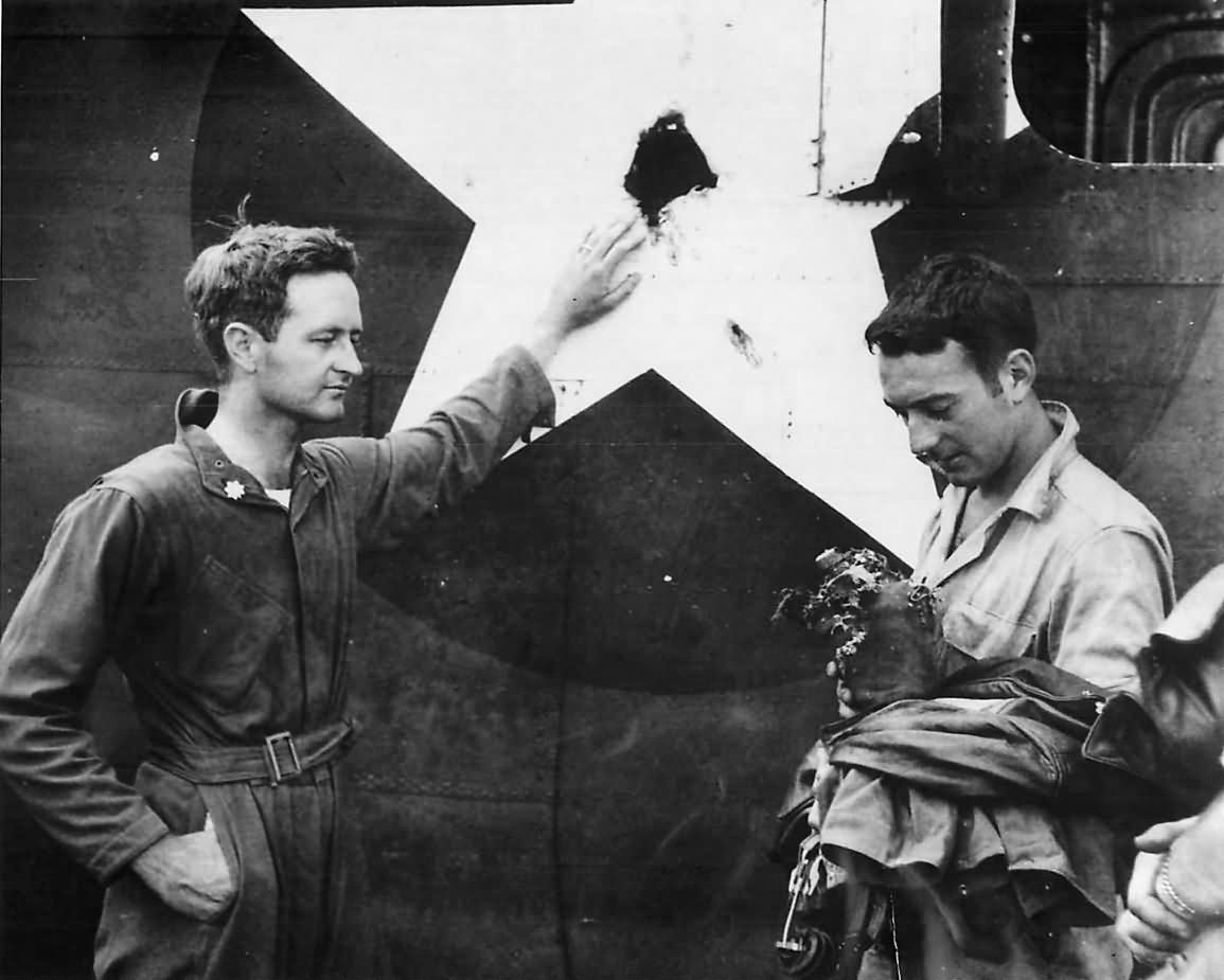 Major Richard Craig inspects hole in his B-24 made by A6M during raid on Gastmata New Britain 1943