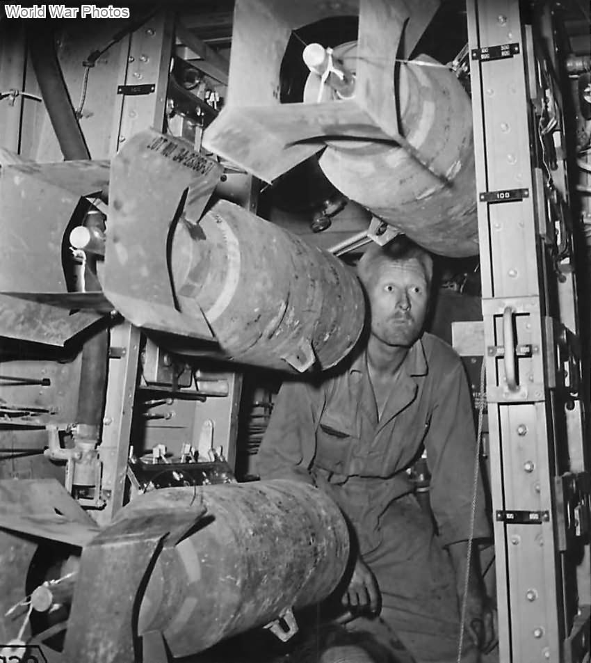 Ground crewman loading bomb racks of B-26 for raid on Sicily 1943