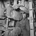 Ground crewman loading bomb racks of B-26 for raid on Sicily 1943