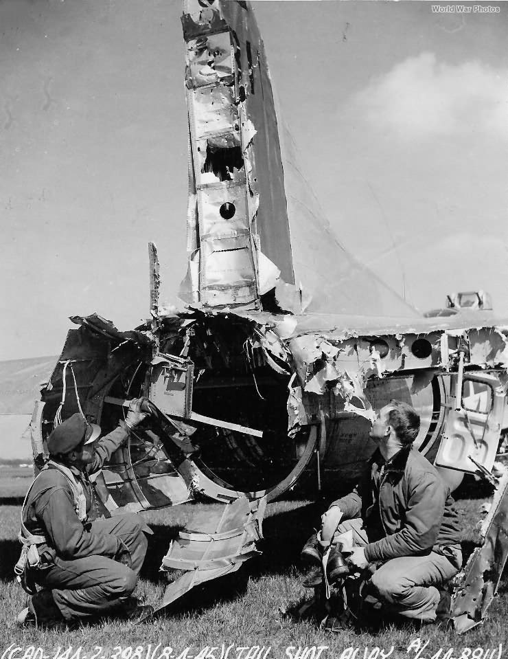 398th BG Airmen look at shot up B-17 44-8811
