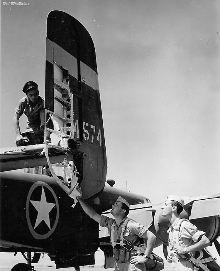 Aircrew checking out Flak damage on their B-25 ’43