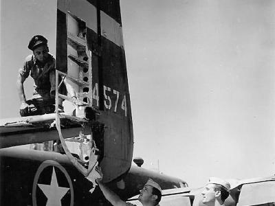 Aircrew checking out Flak damage on their B-25 ’43
