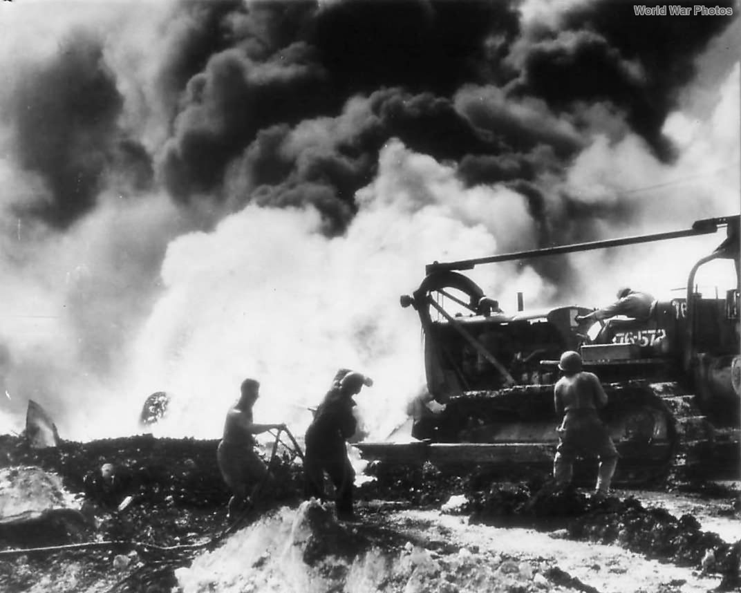 Aviation Engineers man bulldozer bybAviation Engineers man bulldozer by burning B-29 on Saipan December 1944urning B-29 on Saipan dec44